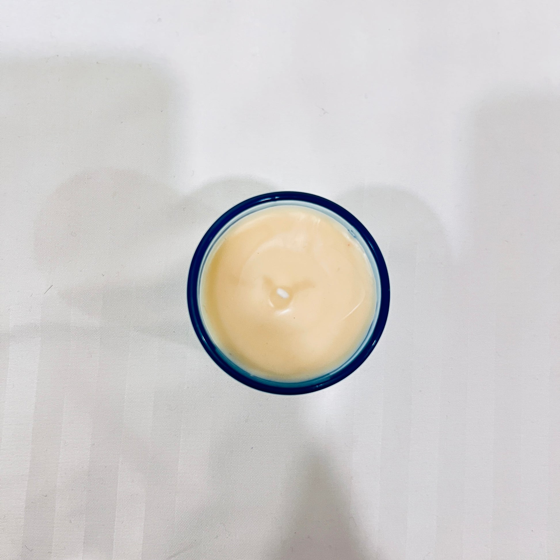 Top view of Jaivik Store Aqua Wave soy wax candle, 60g, showcasing a smooth wax surface and premium finish