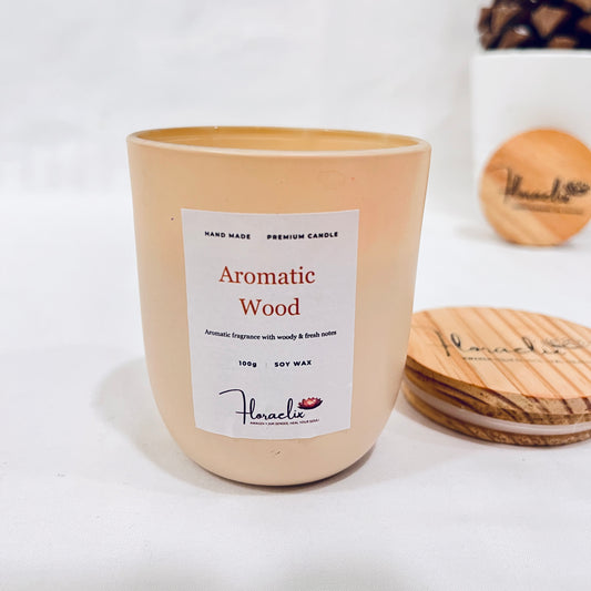 Jaivik Store Aromatic Wood soy wax candle, 100g, lid open, set against a pine fruit backdrop for natural charm