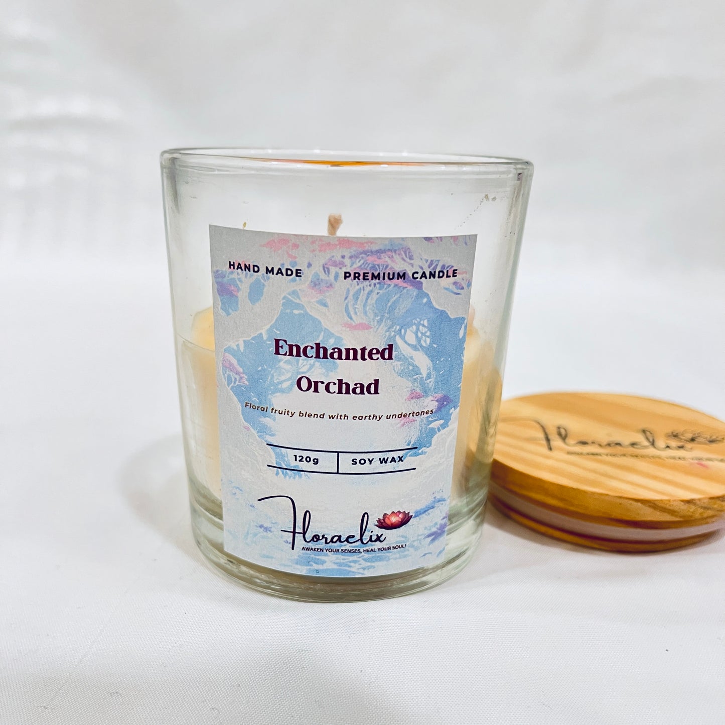 Front view of Jaivik Store Enchanted Orchard Daisy soy wax candle, 120g, lid open, showcasing vibrant elegance