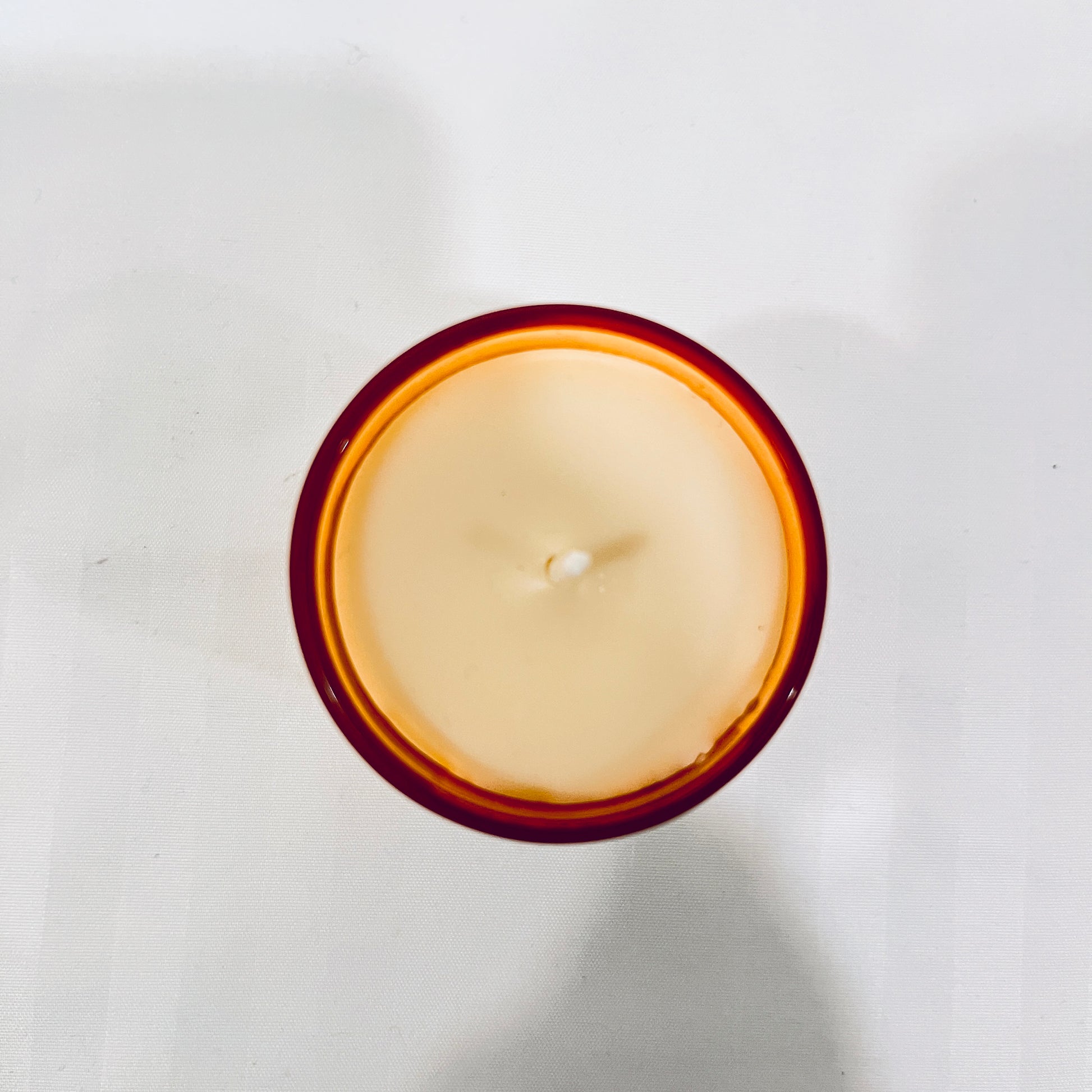 Top view of Jaivik Store Soothing Geranium Breeze soy wax candle, 60g, highlighting the smooth wax surface and premium finish