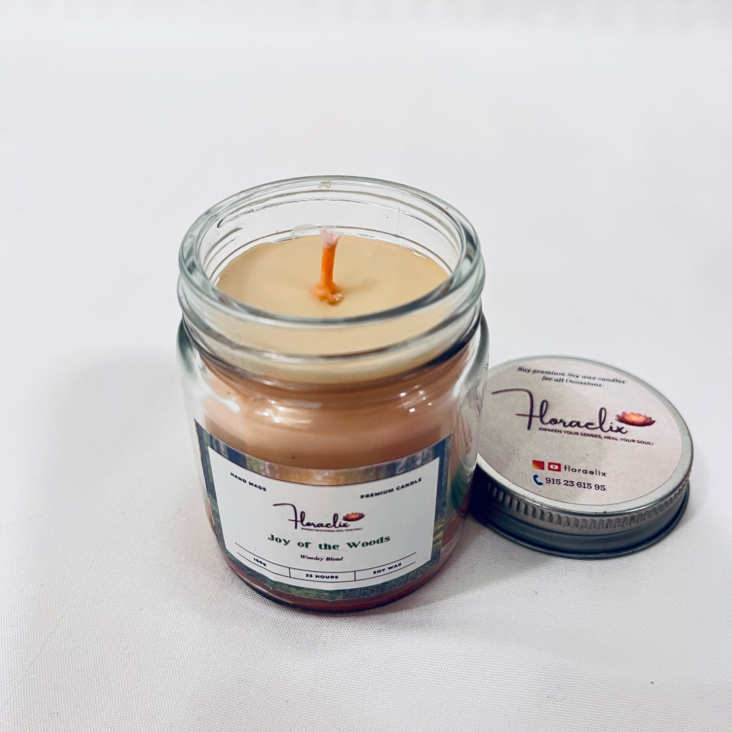 Close-up of Jaivik Store Joy of the Wood soy wax candle, 100g, lid open, with wick visible, offering premium detail