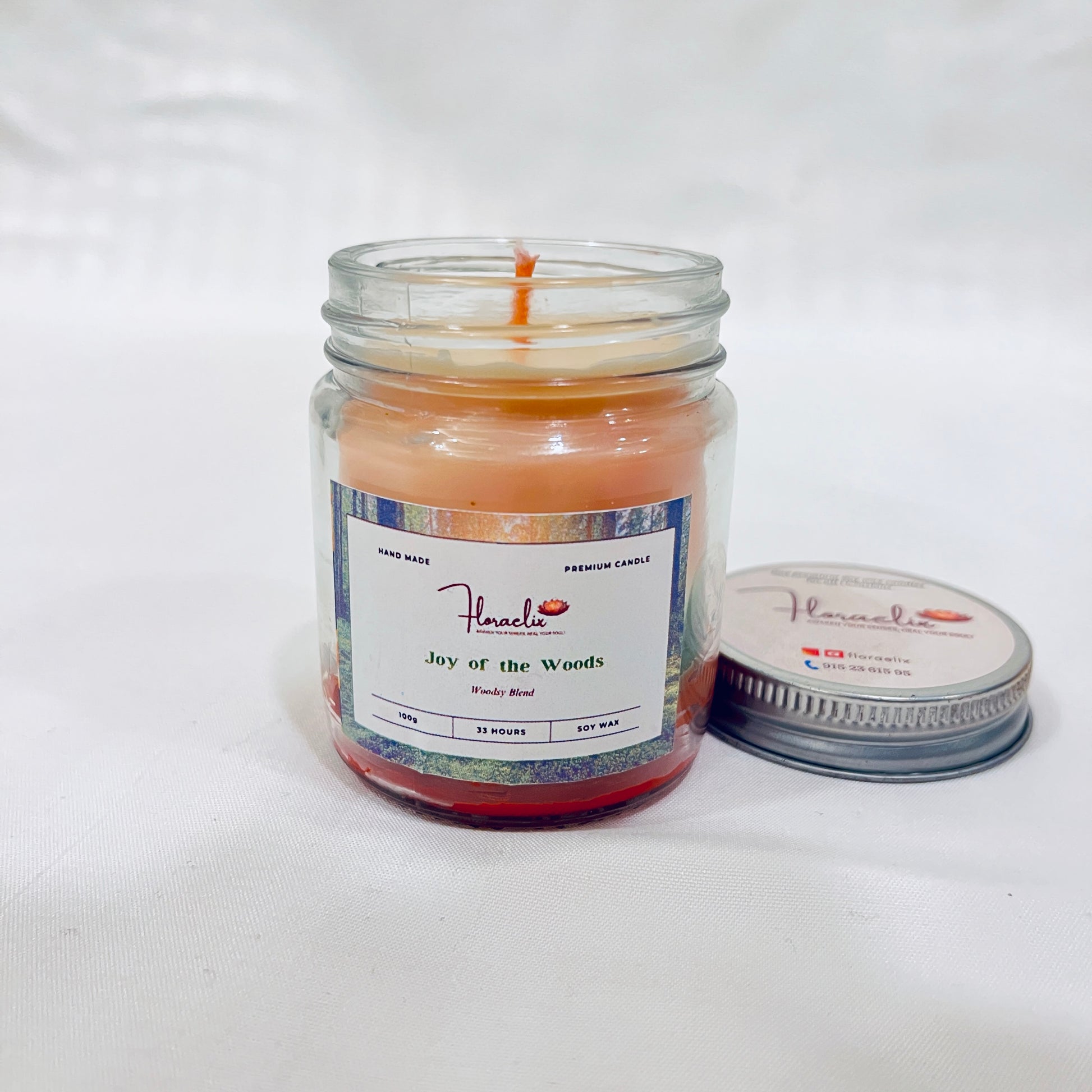 Front view of Jaivik Store Joy of the Wood soy wax candle, 100g, lid open, showcasing rustic and warm aesthetics