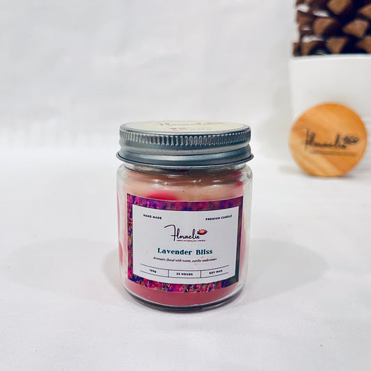 Jaivik Store Lavender Bliss soy wax jar candle, 100g, with lid open, displayed against a pine fruit backdrop for natural charm