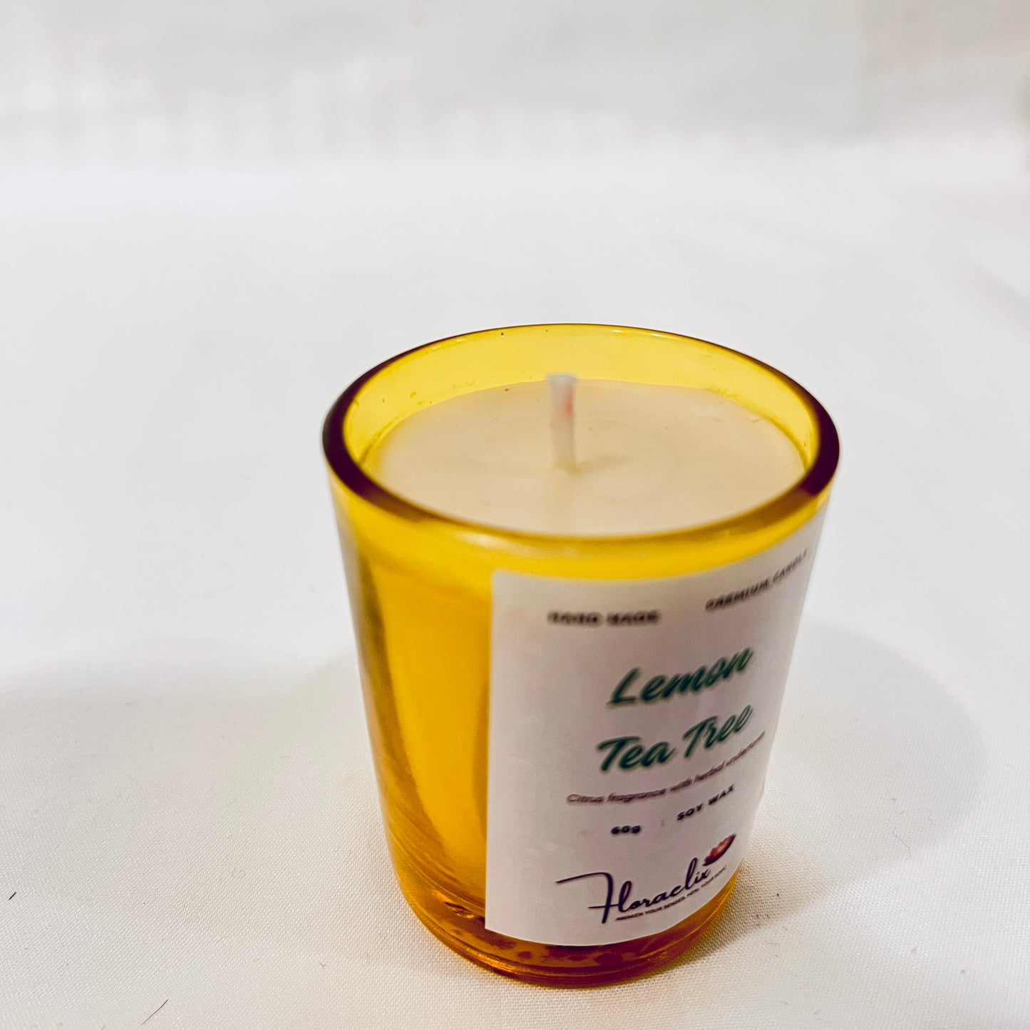 Close-up of Jaivik Store Energizing Lemon & Tea Tree soy wax candle for aromatherapy, 60g, with wick visible, showcasing premium quality