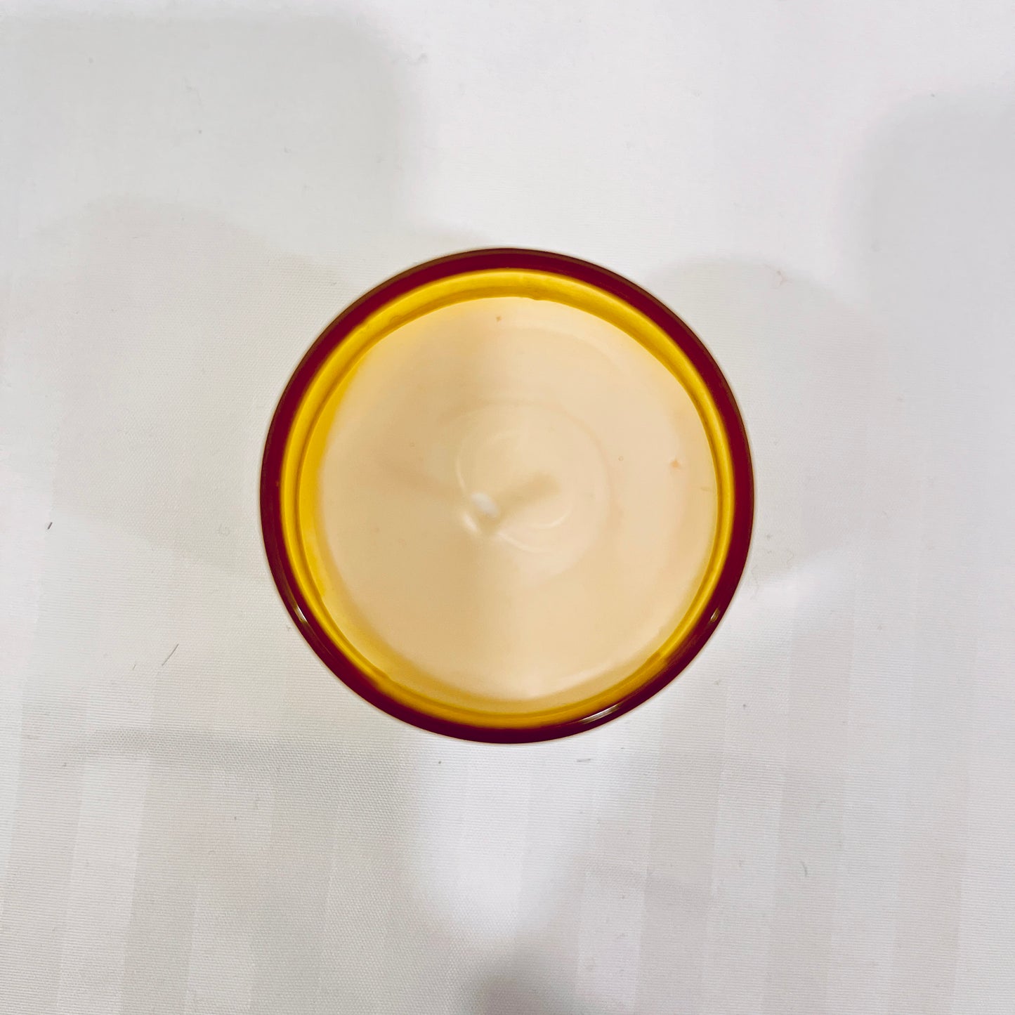 Top view of Jaivik Store Energizing Lemon & Tea Tree soy wax candle for aromatherapy, 60g, revealing a smooth wax finish