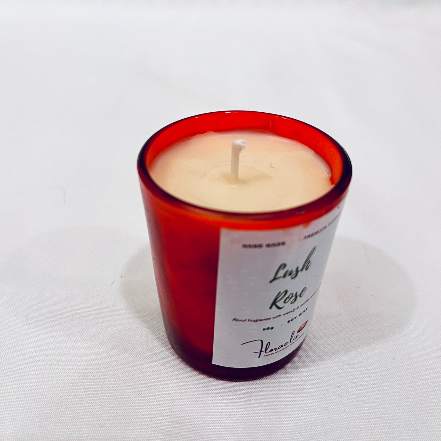 Close-up of Jaivik Store Lush Rose premium soy wax candle for aromatherapy, 60g, with wick visible, highlighting fine detail