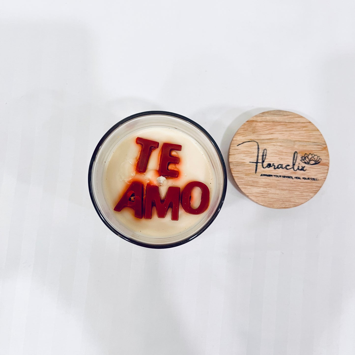 Top view of Jaivik Store Te Amo premium scented soy wax jar candle, 150g, with lid open, revealing smooth wax surface